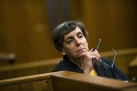 FILE- In this Feb. 5, 2018, file photo, defendant Liane Shekter Smith listens during a preliminary examination in the cases of four defendants, all former or current officials from the Michigan Department of Environmental Quality, in Flint, Mich. Shekter Smith, the only Michigan official fired in the Flint water disaster, was likely a “public scapegoat” who lost her job because of politics, an arbitrator said in ordering $191,880 in back pay and other compensation. (Jake May/The Flint Journal via AP, File)