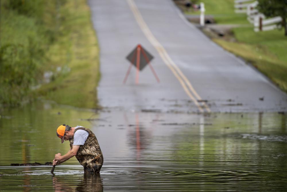 Dickson Public Works personnel check the flooding on Old Pond Lane following heavy rainfall, Saturday, Aug. 21, 2021, in Dickson, Tenn. Heavy flooding in several Middle Tennessee counties on Saturday prompted water rescues, road closures, and communications disruptions, with several people reported missing. Flash flood warnings were in effect for Dickson, Houston and Montgomery and Stewart counties on Saturday evening. (Josie Norris/The Tennessean via AP)