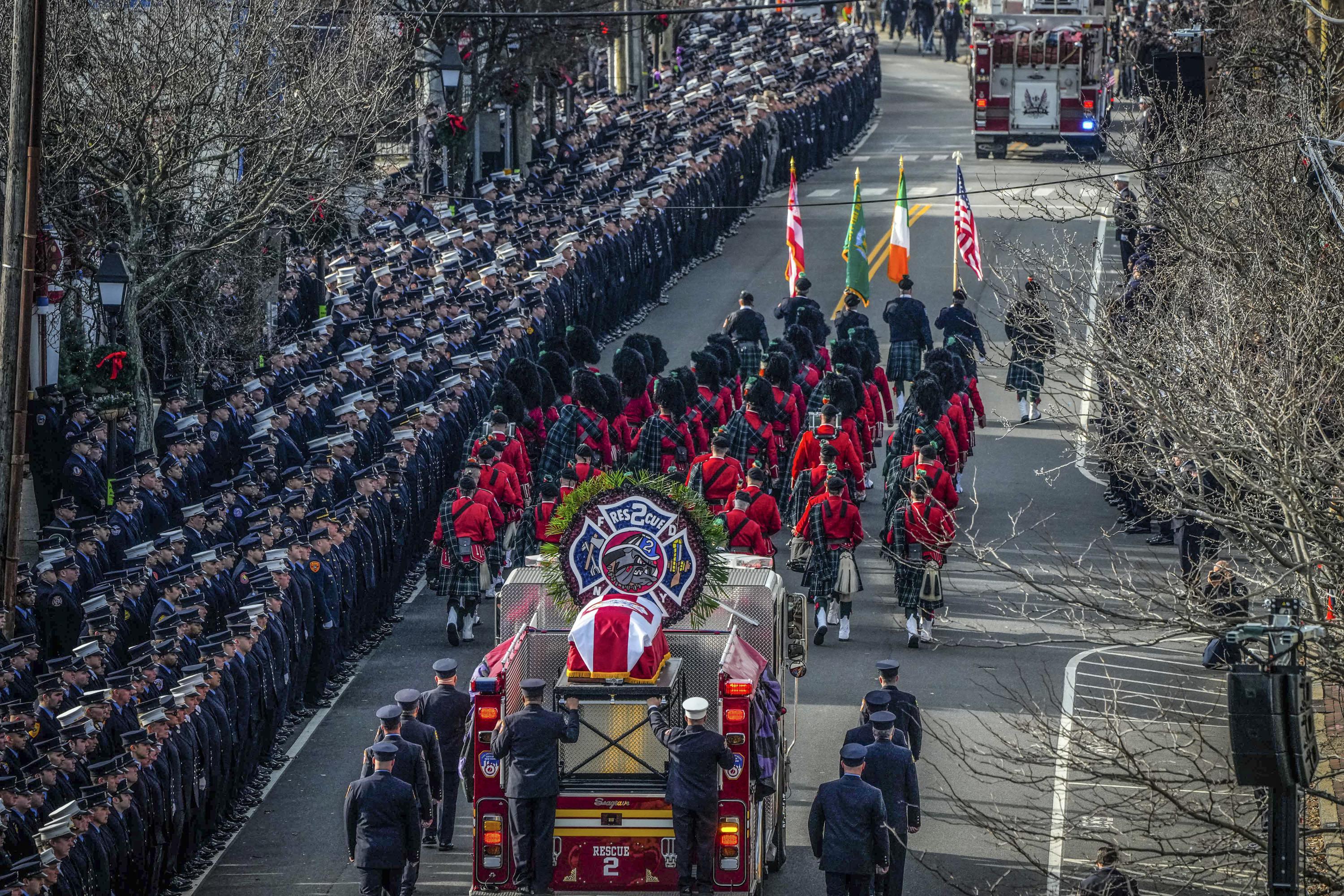 Hundreds fill church, line streets for firefighter's funeral | AP News