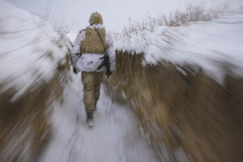 A Ukrainian serviceman walks through a trench on the front line in the Luhansk area, eastern Ukraine, Thursday, Jan. 27, 2022. The U.S. rejection of Russia's main demands to resolve the crisis over Ukraine left little ground for optimism, the Kremlin said Thursday, but added that dialogue was still possible. (AP Photo/Vadim Ghirda)