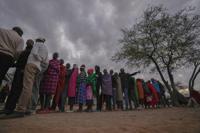 People line up to vote at the Oltepesi Primary School in Kajiado County, Nairobi, Kenya, Tuesday, Aug. 9, 2022. Kenyans are voting to choose between opposition leader Raila Odinga and Deputy President William Ruto to succeed President Uhuru Kenyatta after a decade in power. (AP Photo/Ben Curtis)