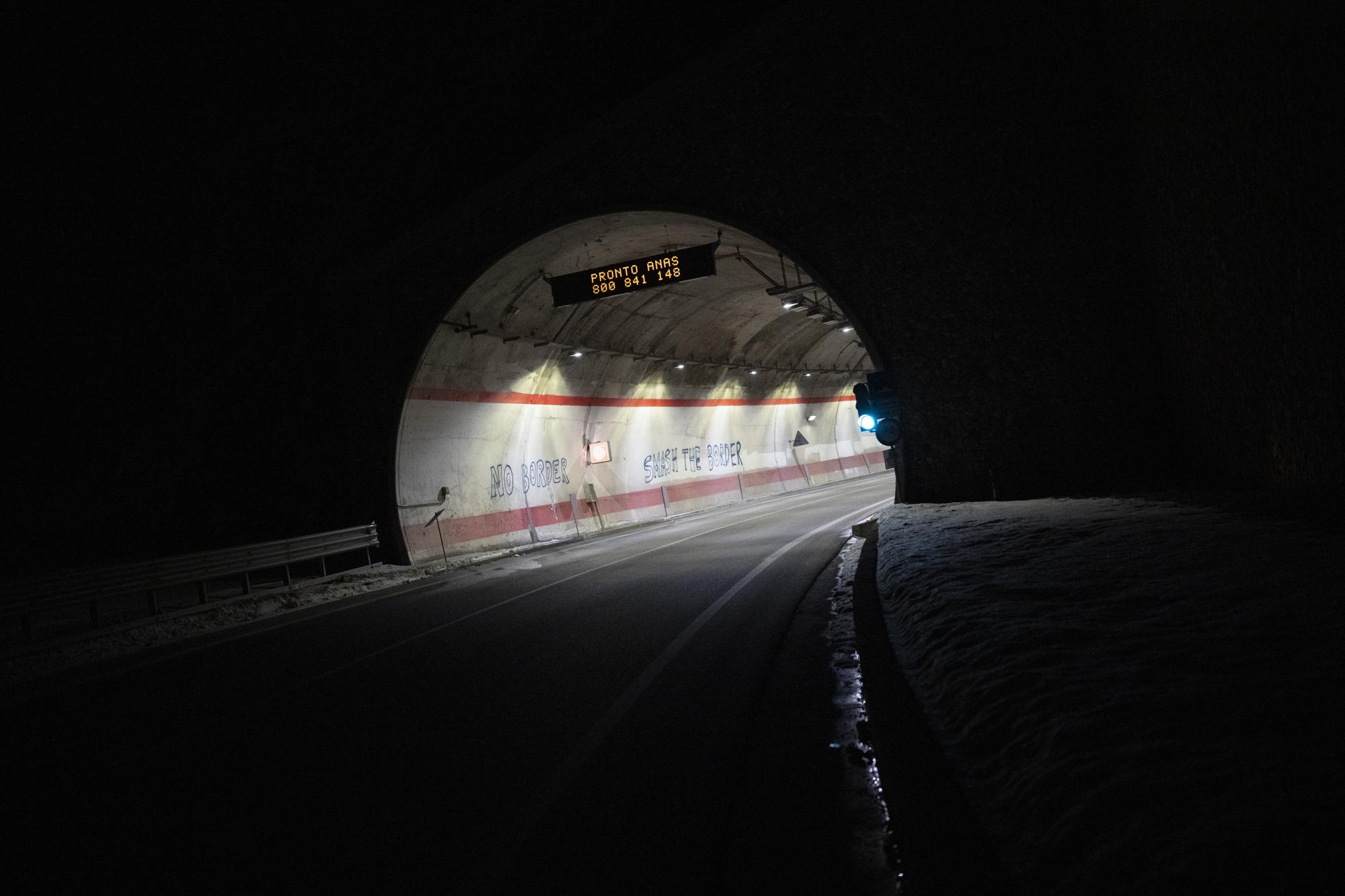 Graffiti reading "no border" is pictured on a mountain road walked by migrants leading to the French-Italian border, Wednesday, Dec. 15, 2021. (AP Photo/Daniel Cole)