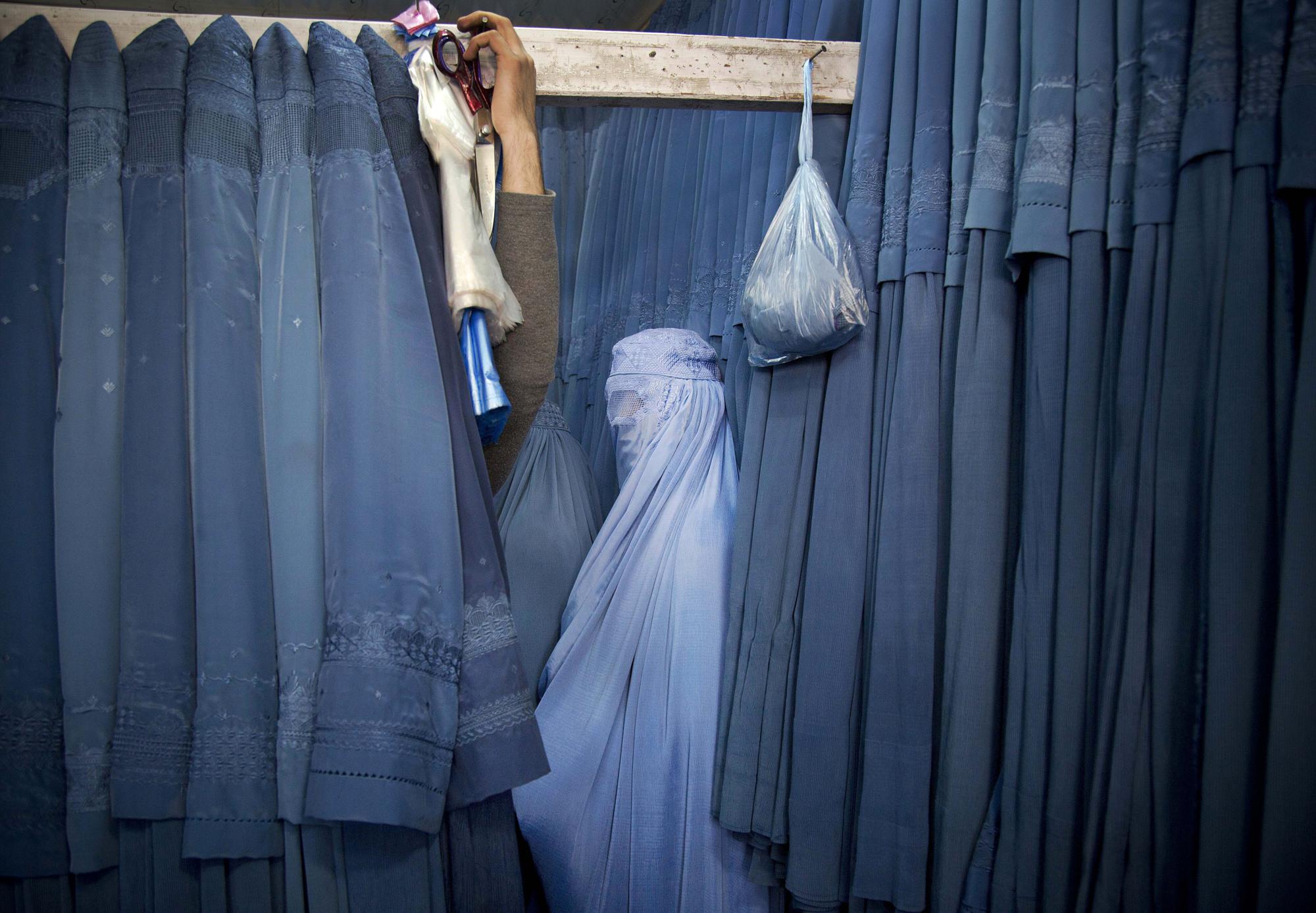 An Afghan woman waits in a changing room to try out a new Burqa, in a shop in the old city of Kabul, Afghanistan, Thursday, April 11, 2013. Before the Taliban took power in Afghanistan, the Burqa was infrequently worn in cities. While they were in power, the Taliban required the wearing of a Burqa in public. (AP Photo/Anja Niedringhaus)