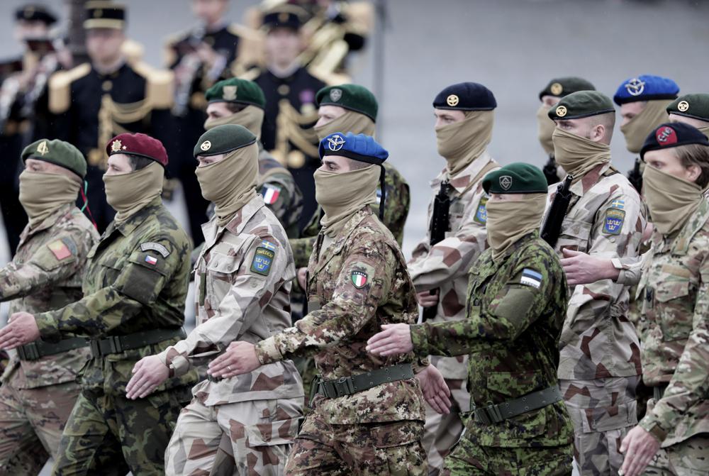 FILE - Soldiers from the European Task force Takuba march during the annual Bastille Day parade on the Champs-Elysees in Paris, Wednesday July 14, 2021. A European military task force fighting extremists in Mali has formally withdrawn from the West African country amid tensions with its ruling military junta. The French military spearheaded the Takuba task force, and announced Friday, July 1, 2022 that it officially ended its work. (AP Photo/Lewis Joly, File)