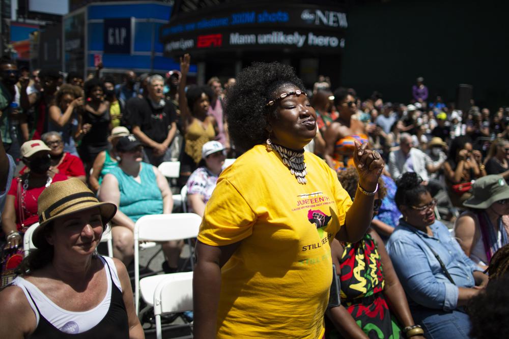 People attend a free outdoor event organized by The Broadway League as celebrations during Juneteenth take place at Times Square Saturday, June 19, 2021, in New York. Parades, picnics and lessons in history marked Juneteenth celebrations in the U.S., a day that marks the arrival of news to enslaved Black people in a Texas town that the Confederacy had surrendered in 1865 and they were free. (AP Photo/Eduardo Munoz Alvarez)