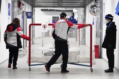 A hockey net is moved down a hallway as the National Indoor Stadium is prepared for ice hockey at the 2022 Winter Olympics, Monday, Jan. 31, 2022, in Beijing. (AP Photo/Mark Humphrey)