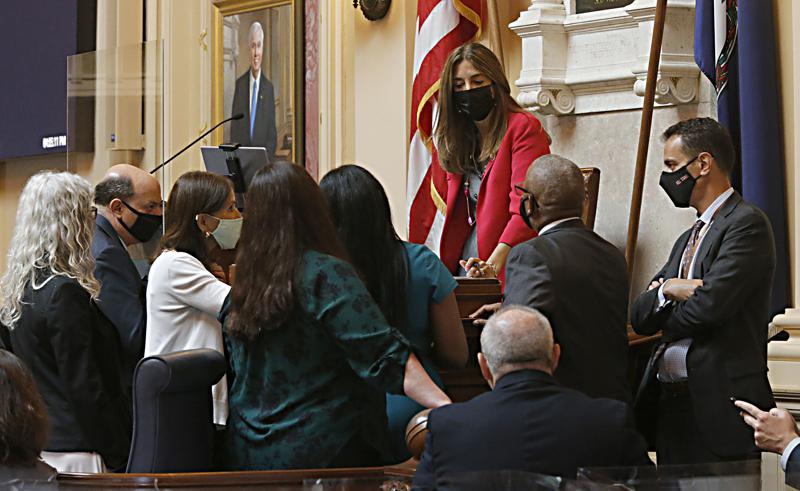 House staff and Democratic members of the House of Delegates gather around the desk of Speaker Eileen Filler-Corn, D-Fairfax, center, before the budget bill was voted on at the Virginia State Capitol in Richmond, Va., Tuesday, Aug. 3, 2021, on the second day of the General Assembly Special Session. (Bob Brown/Richmond Times-Dispatch via AP)