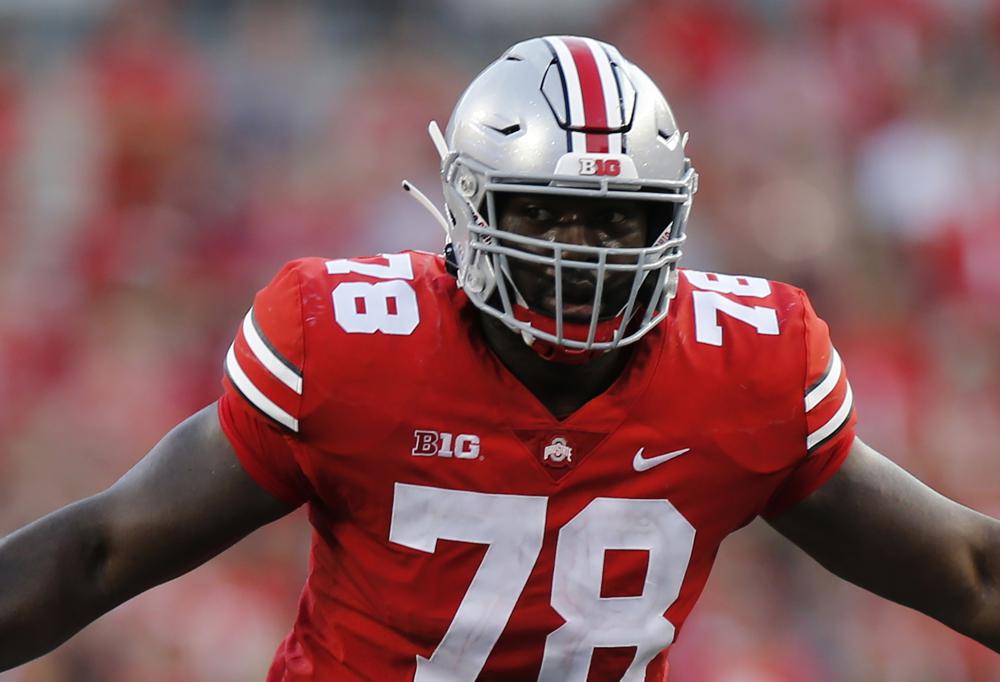 FILE -Ohio State offensive lineman Nicholas Petit-Frere plays against Tulsa during an NCAA college football game Saturday, Sept. 18, 2021, in Columbus, Ohio. This year's NFL draft prospects reluctantly recall their personal COVID-19 experiences. Some consider them inspirational reminders of obstacles already overcame. Others sound more reminiscent of old war stories. And while the stories change, each comes with unforgettably vivid detail and heartfelt emotion about a challenging two-year battle to pursue their dreams.(AP Photo/Jay LaPrete, File)