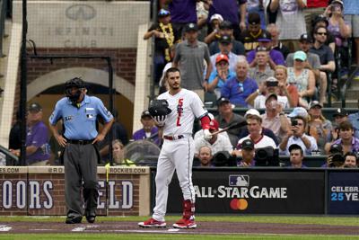 National League's Nolan Arenado, of the St. Louis Cardinals, acknowledges the crowd during the first inning of the MLB All-Star baseball game, Tuesday, July 13, 2021, in Denver. (AP Photo/Gabriel Christus)