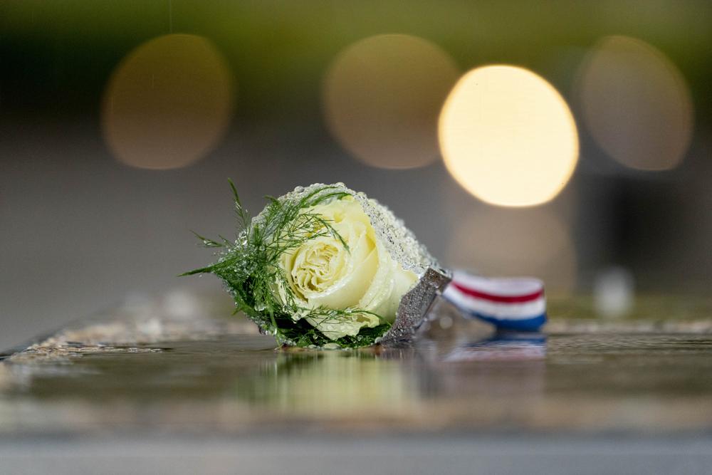 A flower is visible on one of the benches at the National 9/11 Pentagon Memorial outside the Pentagon in Washington, Sunday, Sept. 11, 2022, on the morning of the 21st anniversary of the 9/11 terrorist attacks. (AP Photo/Andrew Harnik)