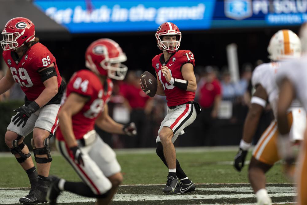 Heisman Watch Georgia quarterback Stetson Bennett (13) throws from the pocket during the first half of an NCAA college football game against Tennessee, Saturday, Nov. 5, 2022 in Athens, Ga. (AP Photo/John Bazemore)