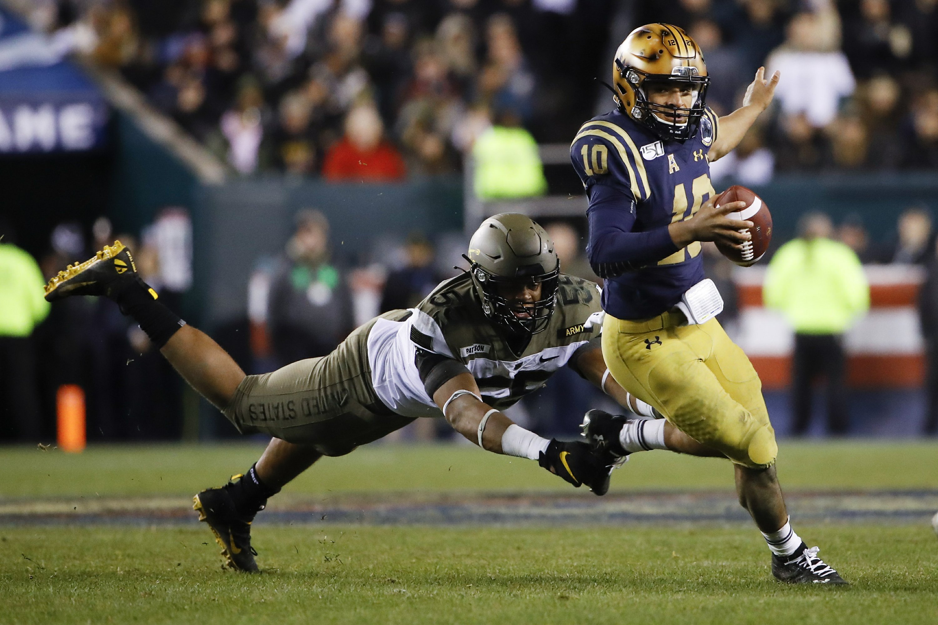 Recordsetting Navy QB Perry will get NFL shot with Dolphins AP News