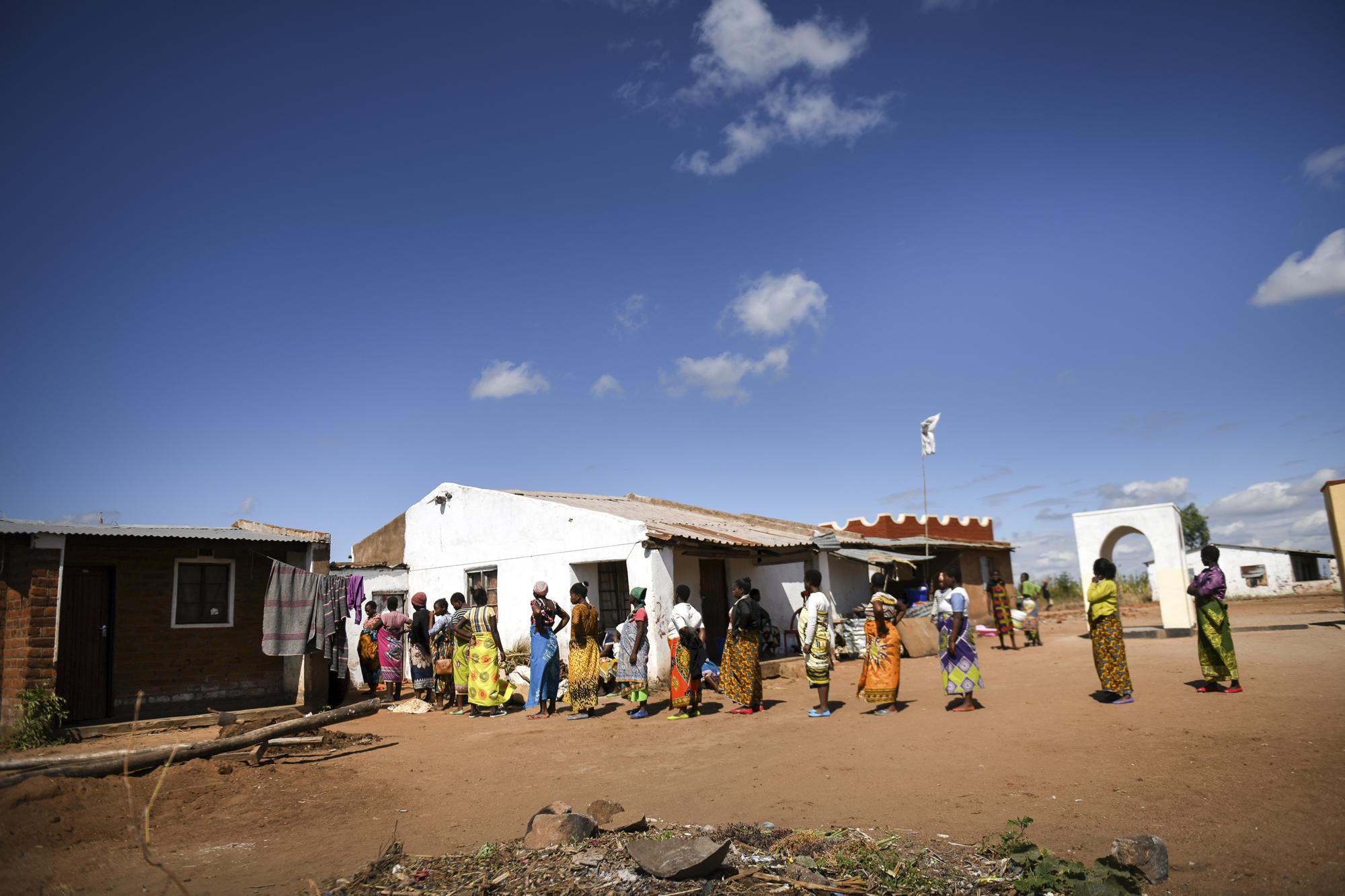 Pregnant women queue to see Lucy Mbewe, a traditional birth attendant at her home, in Simika Village, Chiradzulu, southern Malawi, Sunday, May 23, 2021. Health officials in Malawi say fewer women are getting prenatal care amid the COVID-19 pandemic. At risk are the developing country's gains on its poor rate of maternal deaths. (AP Photo/Thoko Chikondi)