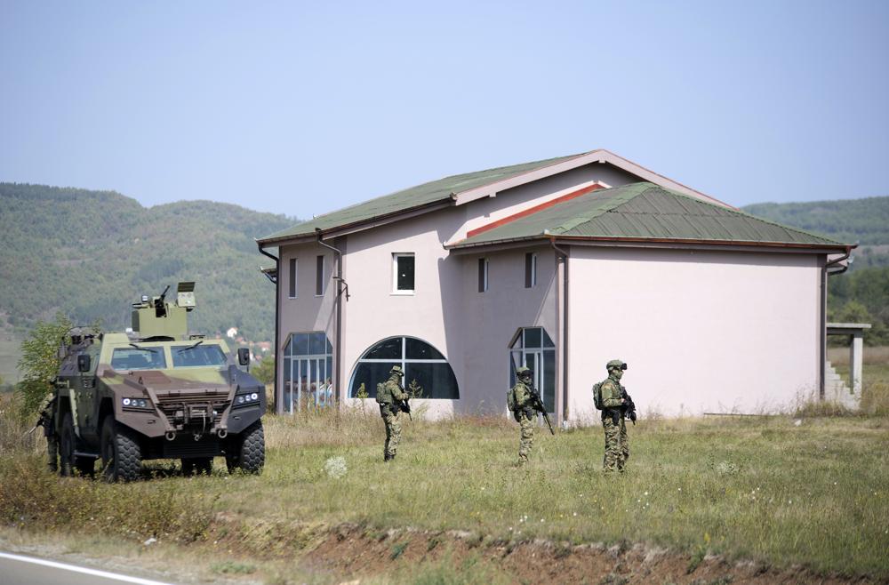 Serbian Army soldiers guard a road near the village of Rudnica, Serbia, by the border with Kosovo, Monday, Sept. 27, 2021. Serbia has put its army troops in regions near Kosovo on higher alert. Ethnic Kosovo Serbs have blocked the Kosovo-Serbia border with trucks since Monday, angry that Kosovo sent in special police to match Serbia in a license plate move that heightens tensions in the Balkans. Kosovo now removes license plates from cars entering the country from Serbia, as Serbia does with Kosovo plates. (AP Photo/Marjan Vucetic)