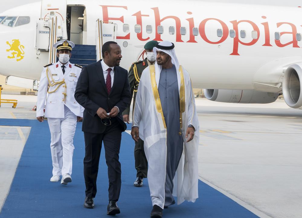 In this photo released by the United Arab Emirates' state-run WAM news agency, Abu Dhabi's powerful crown prince, Sheikh Mohammed bin Zayed Al Nahyan, right, greets Ethiopian Prime Minister Abiy Ahmed after his arrival in Abu Dhabi, United Arab Emirates, Saturday, Jan. 29, 2022. Ahmed is in the United Arab Emirates on a state visit amid his country's ongoing war against Tigray rebels. (Abdulla Al Neyadi/Ministry of Presidential Affairs/WAM via AP)