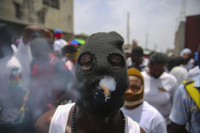 ARCHIVO - En esta fotografía de archivo del 26 de julio de 2021, un miembro de la pandilla encabezada por Jimmy Cherizier, alias Barbecue, participa en una marcha para exigir justicia por el homicidio del presidente Jovenel Moïse, en Puerto Príncipe, Haití. (AP Foto/Joseph Odelyn, archivo)