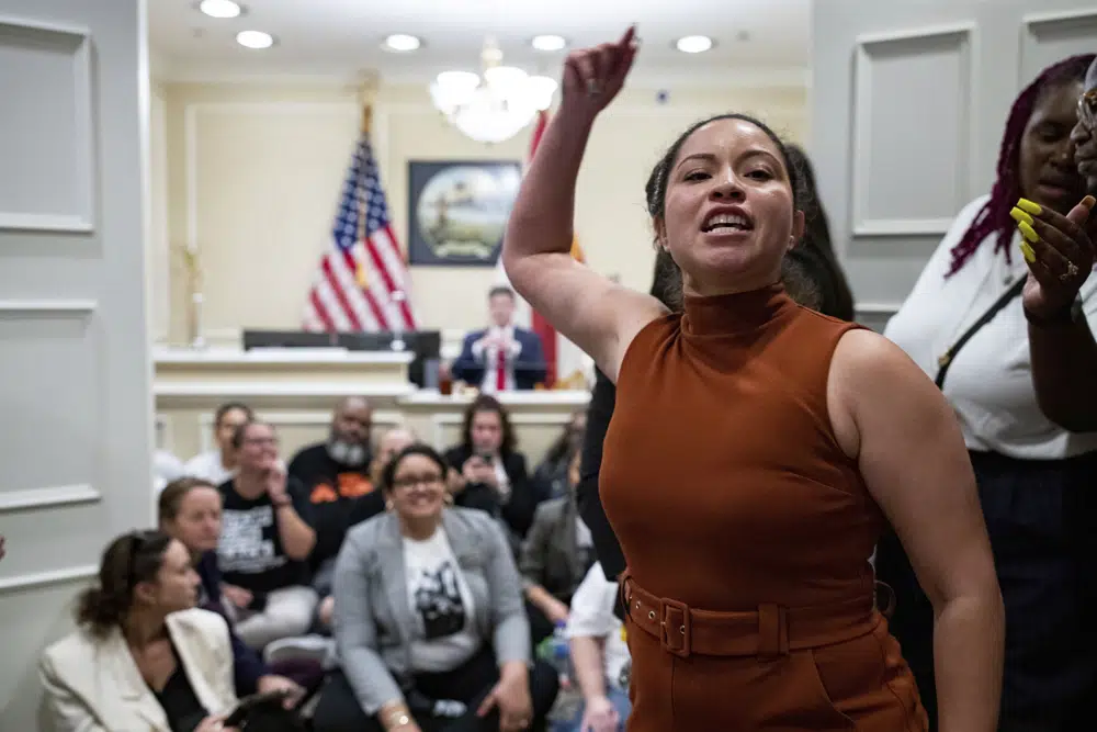 Yareliz Mendez Zamora leads a chant for dozens of activists during a sit-in outside Florida Gov. Ron DeSantis' office, Wednesday, May 3, 2023, in Tallahassee, Fla. (Alicia Devine/Tallahassee Democrat via AP)