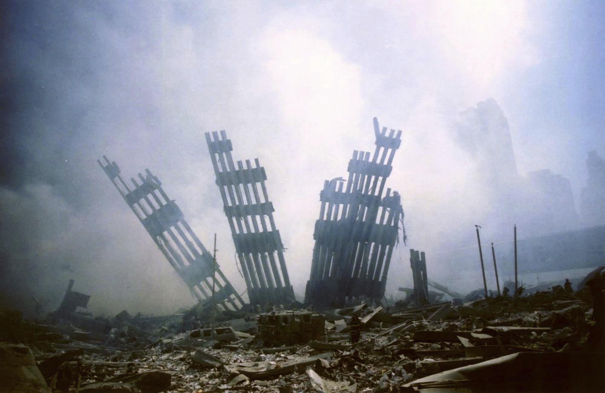 ADVANCE FOR PUBLICATION ON SUNDAY, SEPT. 5, AND THEREAFTER - FILE - In this Tuesday, Sept. 11, 2001 file photo, the remains of the World Trade Center stand amid other debris following the terrorist attack on the buildings in New York. (AP Photo/Alexandre Fuchs, File)