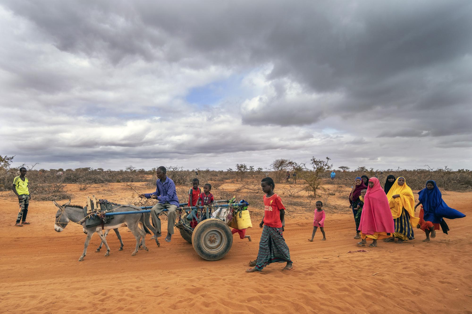 Mohamed Ahmed Diriye arrives with others to a displacement camp on the outskirts of Dollow, Somalia, on Tuesday, Sept. 20, 2022.  Somalia is in the midst of the worst drought anyone there can remember. A rare famine declaration could be made within weeks. Climate change and fallout from the war in Ukraine are in part to blame. (AP Photo/Jerome Delay)