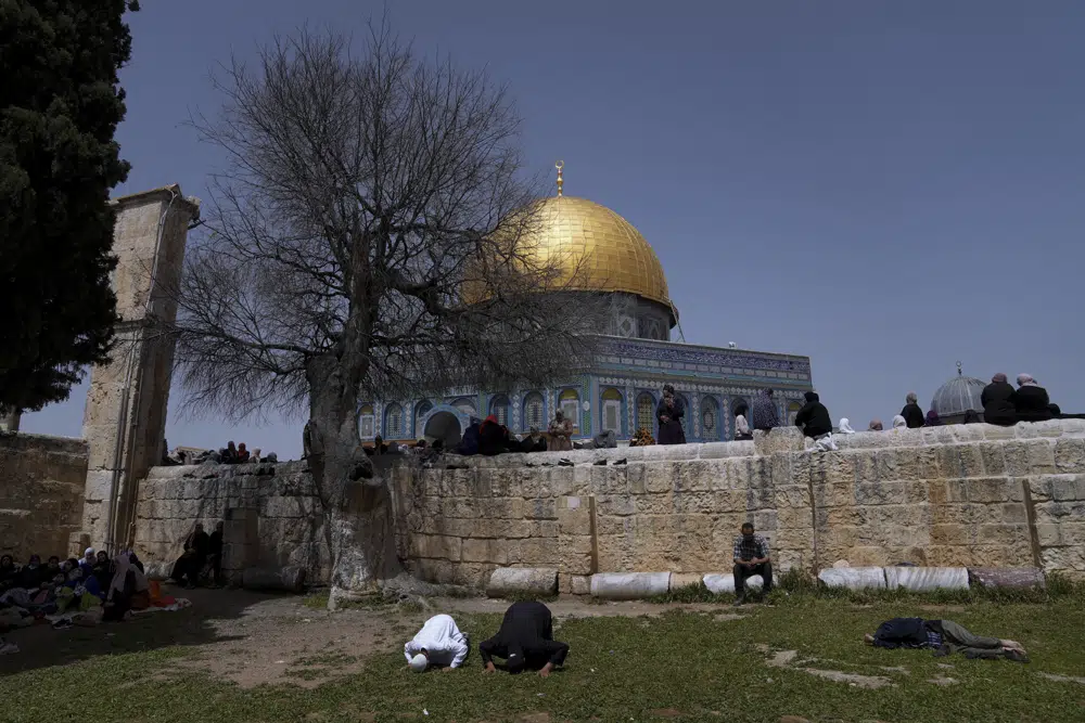 Muslim worshippers perform Friday prayers outside the Dome of Rock Mosque at the Al-Aqsa Mosque compound in the Old City of Jerusalem during the Muslim holy month of Ramadan, Friday, April 7, 2023. (AP Photo/Mahmoud Illean)