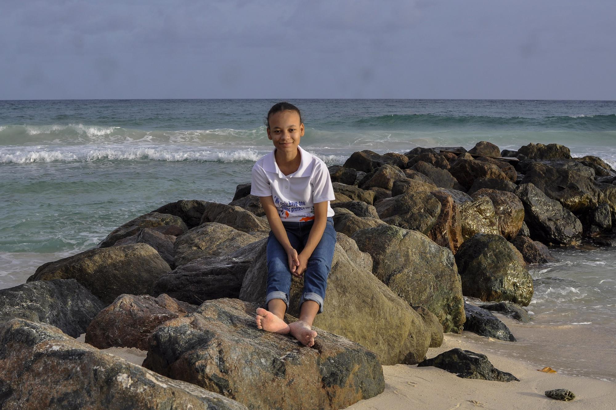 FILE - Environmental activist and film maker Maria Marshall poses for a photo on the beach in Hastings, Barbados, Sunday, April 16, 2023. "The fact still remains," she says. "we still have only one environment we've got to protect." (AP Photo/Kerrie Eversley)