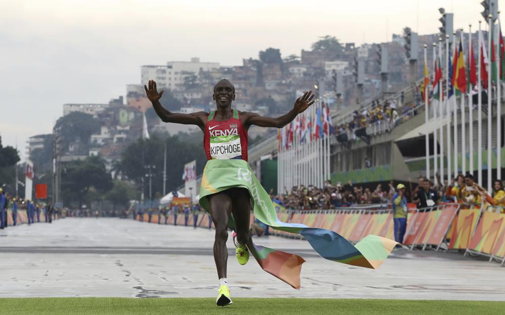 FILE - In this Aug. 21, 2016, file photo, Kenya's Eliud Kipchoge crosses the finish line to win the men's marathon at the 2016 Summer Olympics in Rio de Janeiro, Brazil. The Olympic marathons, along with the race walks, were shifted a four-hour train ride north to Sapporo because of the extreme heat in Tokyo. Kipchoge is the defending champion. (AP Photo/Petr David Josek, File)
