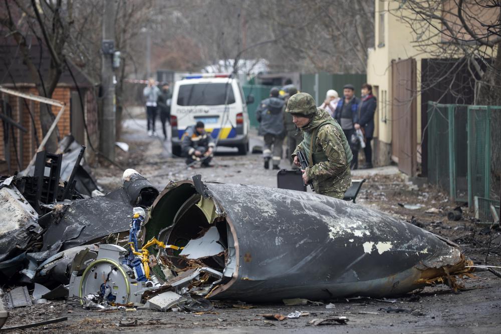 FILE - A Ukrainian Army soldier inspects fragments of a downed aircraft in Kyiv, Ukraine, Feb. 25, 2022. Russia is bracing up for a massive new offensive in eastern Ukraine, hoping to reverse its fortunes on the battlefield after a catastrophic start of the invasion. (AP Photo/Vadim Zamirovsky, File)