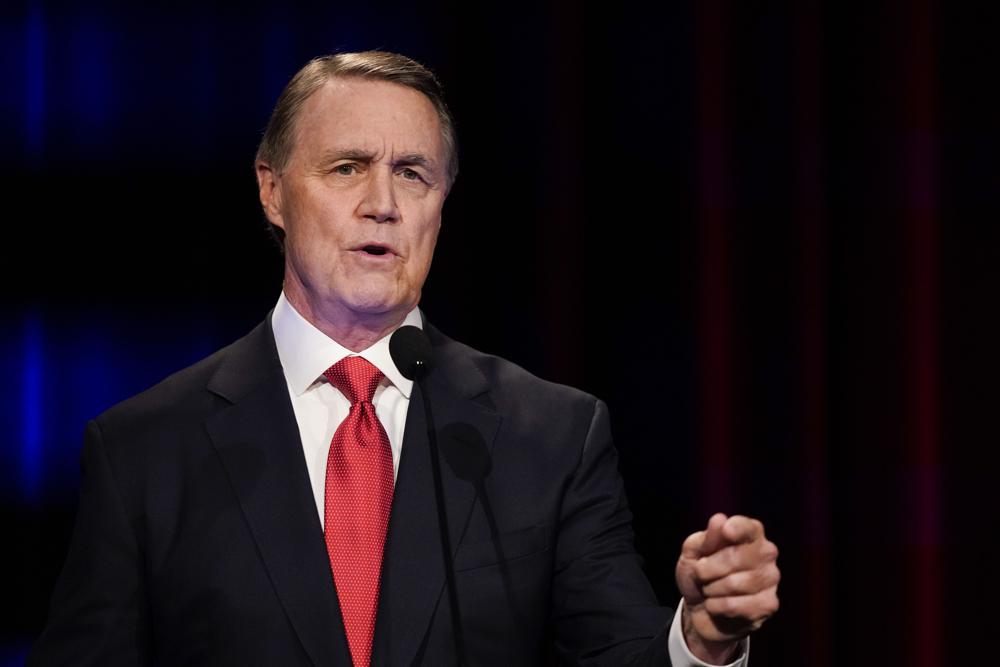 FILE - Former Sen. David Perdue speaks during a gubernatorial republican primary debate on May 1, 2022, in Atlanta. Perdue has made election fraud the centerpiece of his run for Georgia governor. But if he hopes to win in this year's midterm elections, his supporters will have to use the same democratic system he says they shouldn't trust. The only way to win a rigged election, he says, is to turn out in such high numbers that the Democrats can't get away with cheating.(AP Photo/Brynn Anderson, Pool)