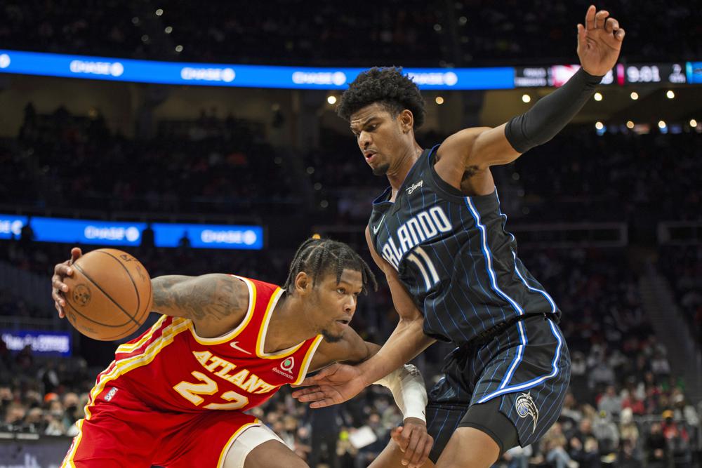 Orlando Magic forward Aleem Ford (11) defends Atlanta Hawks forward Cam Reddish (22) during the second half of an NBA basketball game Wednesday, Dec. 22, 2021, in Atlanta. (AP Photo/Hakim Wright Sr.)