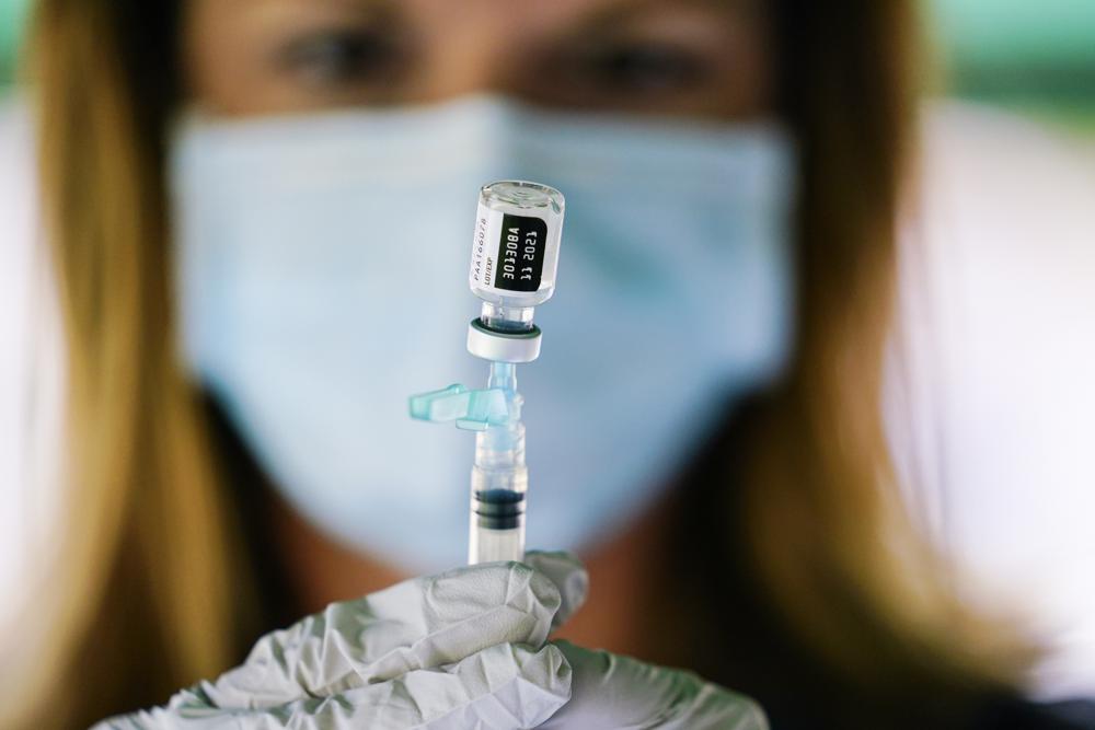 FILE - In this Sept. 14, 2021, file photo, a syringe is prepared with the Pfizer COVID-19 vaccine at a clinic at the Reading Area Community College in Reading, Pa. COVID-19 deaths and cases in the U.S. have climbed back to where they were over the winter, wiping out months of progress and potentially bolstering President Joe Bidenâs case for sweeping new vaccination requirements. (AP Photo/Matt Rourke, File)