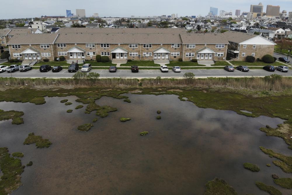 Water pools at the edge of residential district in Atlantic City, N.J., Wednesday, Sept. 4, 2022. Some cities around the world are pulling back from shorelines, as rising seas from climate change increase flooding. But so far, retreat appears out of the question for Atlantic City. (AP Photo/Seth Wenig)