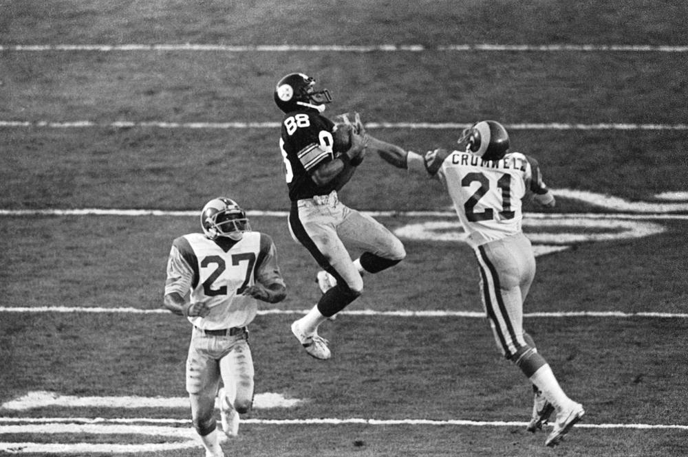 FILE - Pittsburgh Steelers receiver Lynn Swann (88) catches a pass between Los Angeles Rams defenders Nolan Cromwell (21) and Pat Thomas (27) during NFL football's Super Bowl XIV at the Rose Bowl, Jan. 20, 1980, in Pasadena, Calif. The Steelers beat the Rams 31-19. Terry Bradshaw feels blessed to have won four Super Bowls. Lynn Swann is sure he has plenty of teammates who wondered how close they came to stringing together six straight championships. To John Stallworth, winning Super Bowls is just what the Pittsburgh Steelers did. (AP Photo/File)