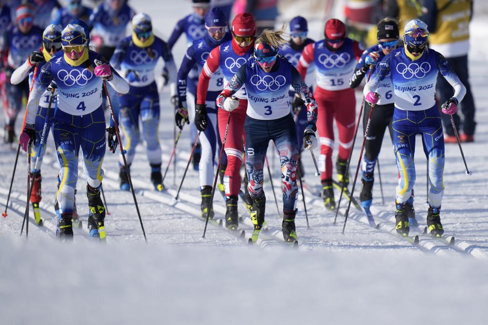 From left, Sweden's Ebba Andersson (4), Norway's Therese Johaug (3) and Sweden's Frida Karlsson (2) compete during the women's 7.5km + 7.5km Skiathlon cross-country skiing competition at the 2022 Winter Olympics, Saturday, Feb. 5, 2022, in Zhangjiakou, China. (AP Photo/Alessandra Tarantino)