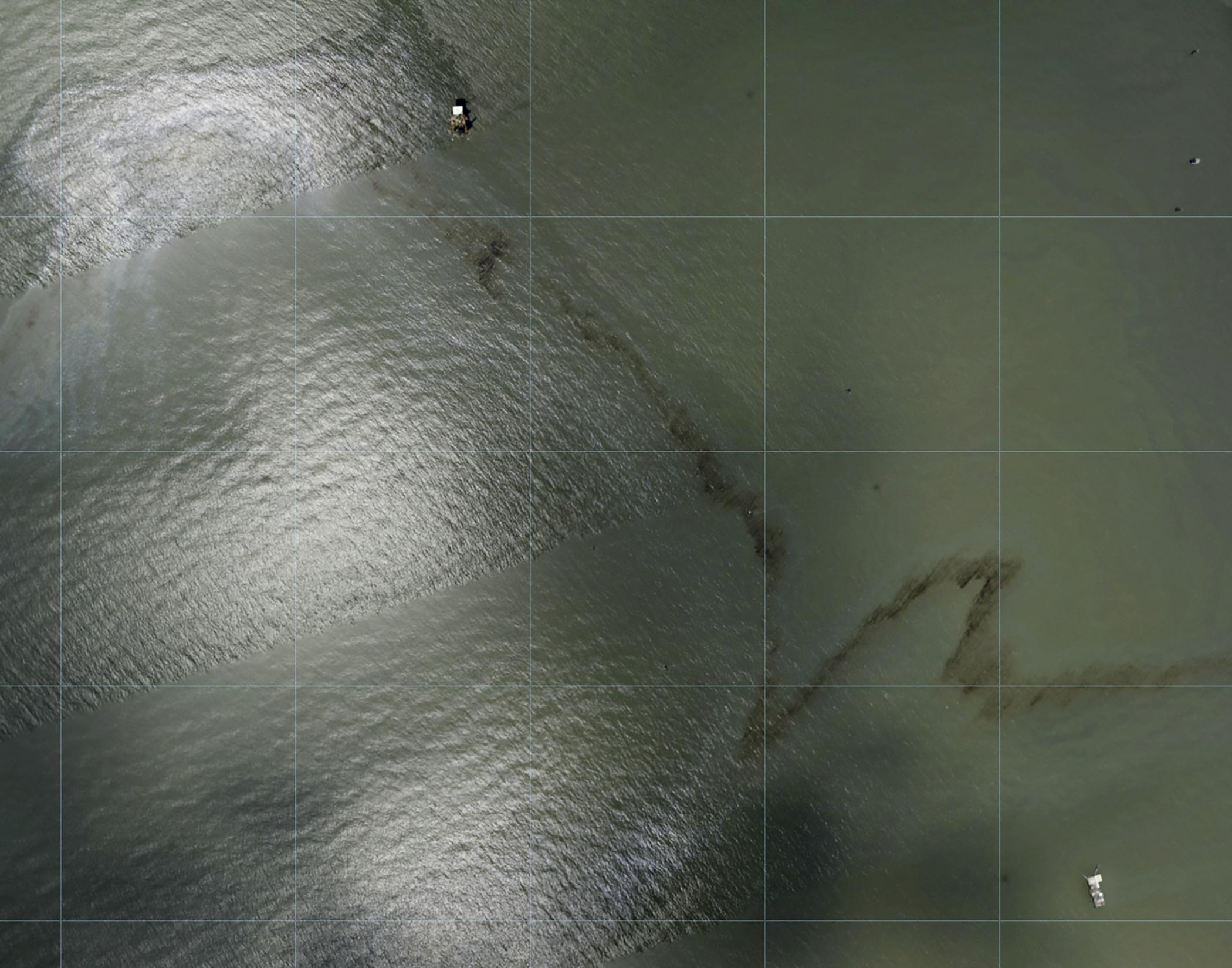 The photos show black spots in the water near the Gulf oil rig after Ida