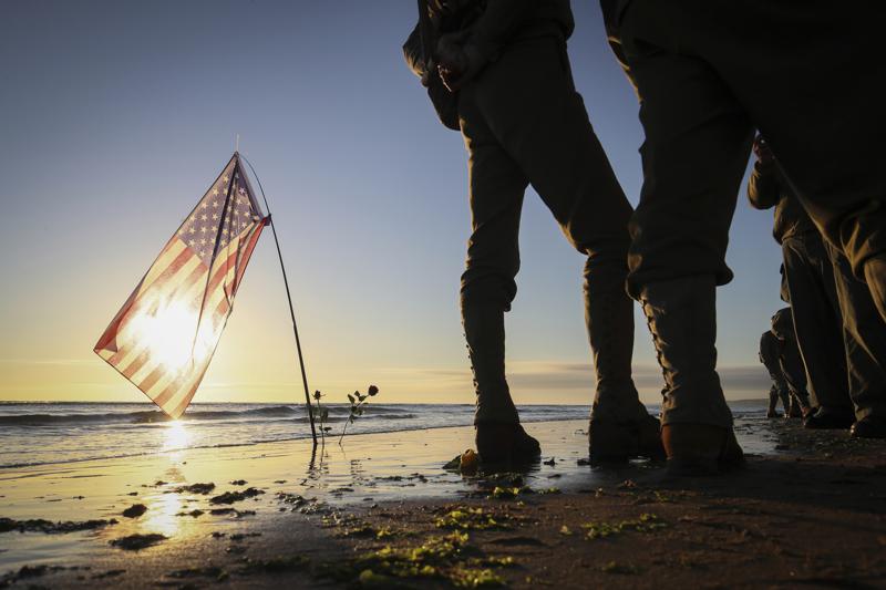 World War II reenactors gather on Omaha Beach in Saint-Laurent-sur-Mer, Normandy, Sunday, June 6, 2021, the day of 77th anniversary of the assault that helped bring an end to World War II. While France is planning to open up to vaccinated visitors starting next week, that comes too late for the D-Day anniversary. So for the second year in a row, most public commemoration events have been cancelled. (AP Photo/David Vincent)