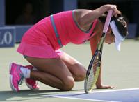 FILE - Peng Shuai, of China, drops to her knees in pain during the semifinals of the 2014 U.S. Open tennis tournament against Caroline Wozniacki, of Denmark, on Sept. 5, 2014, in New York. Struggling to stay upright as suffocating heat and humidity drained her energy in the U.S. Open semifinals, Peng Shuai refused to give up. She paused between points to clutch at her left thigh and put her weight on her racket as if it were a cane. Helped off the court and diagnosed with heat stroke, doctors told her to quit. But Peng still came back for more. Six more points until she eventually collapsed to the ground and Caroline Wozniacki, her opponent in that 2014 match, came around the net to check on her. Only then, with her body pushed to the absolute limit -- maybe even beyond the limit -- did Peng retire from the match that marked the pinnacle of her singles career. (AP Photo/Mike Groll)