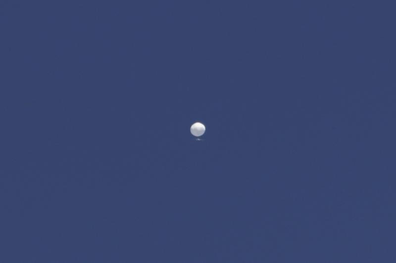 A balloon floats over Columbia, Mo., on Friday, Feb. 3, 2023. A huge, high-altitude Chinese balloon sailed across the U.S. on Friday, drawing severe Pentagon accusations of spying despite China's firm denials. (Anna Griffin/Missourian via AP)