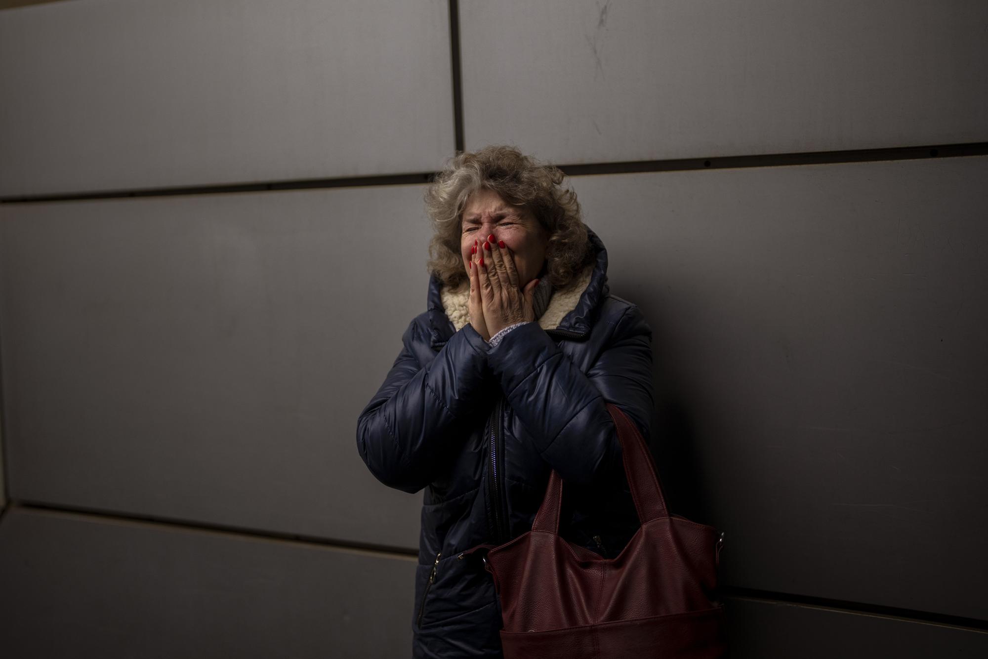 Natalia, 57, cries as she says goodbye to her daughter and grandson on a train to Lviv at the Kyiv station, Ukraine, Thursday, March 3. 2022. (AP Photo/Emilio Morenatti)