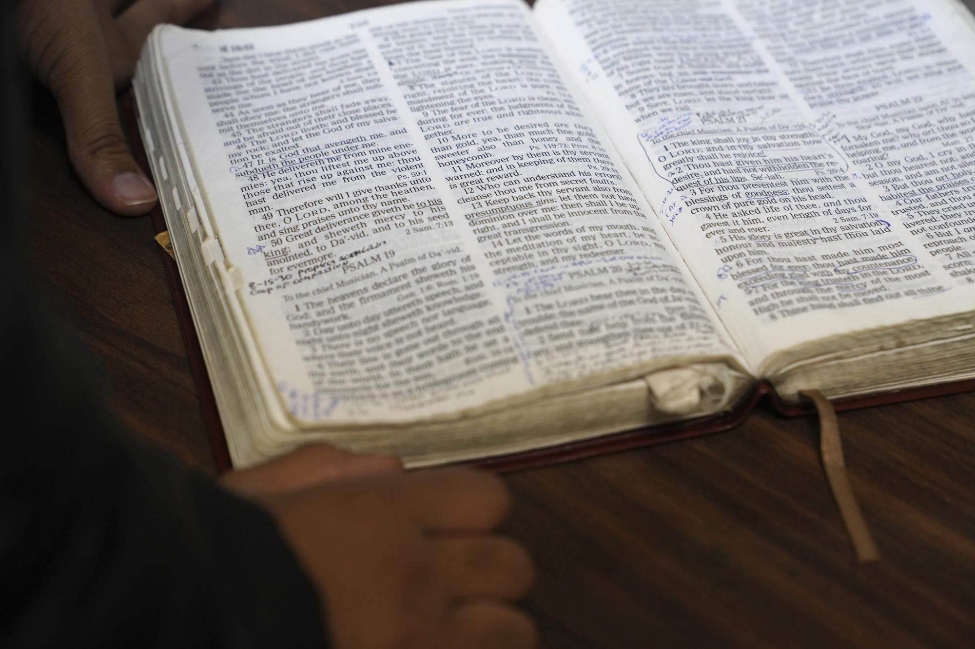 A Bible is opened during an event by the Rastafari Coalition marking the 91st anniversary of the coronation of the late Ethiopian Emperor Haile Selassie I in Columbus, Ohio on Tuesday, Nov. 2, 2021. As public opinion and policy continues to shift in the U.S. and across the world towards the use of marijuana, some adherents of Rastafari question their place in the future of the herb that they consider sacred. (AP Photo/Emily Leshner)