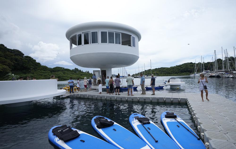 A SeaPod Eco prototype, the first of a futuristic line of homes built over water, is shown to the press in Linton Bay Marina, Panama, Thursday, Sept. 22, 2022. Developers hoped to market these homes that are only accessible by boat off Panama's Caribbean coast but the prototype partially collapsed after its first showing to the press. (AP Photo/Arnulfo Franco)