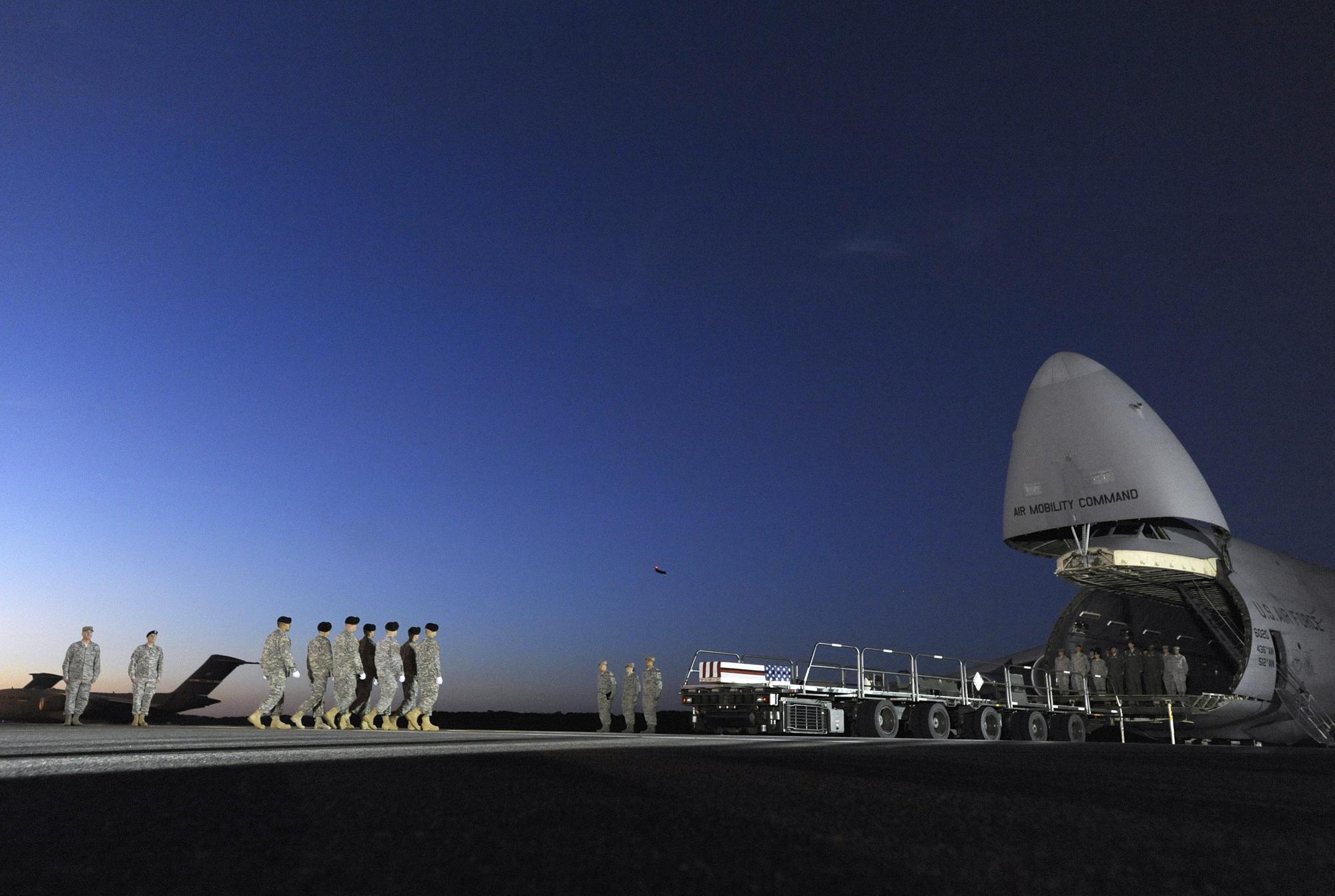 An Army carry team marches toward a transfer case containing the remains of Spc. Kyle E. Gilbert at Dover Air Force Base, Del., Wednesday, Sept. 23, 2015. According to the Department of Defense, Gilbert, 24, of Buford, Ga., died in a non-combat related incident Sept. 21, 2015 in Bagram, Afghanistan. (AP Photo/Steve Ruark, File)