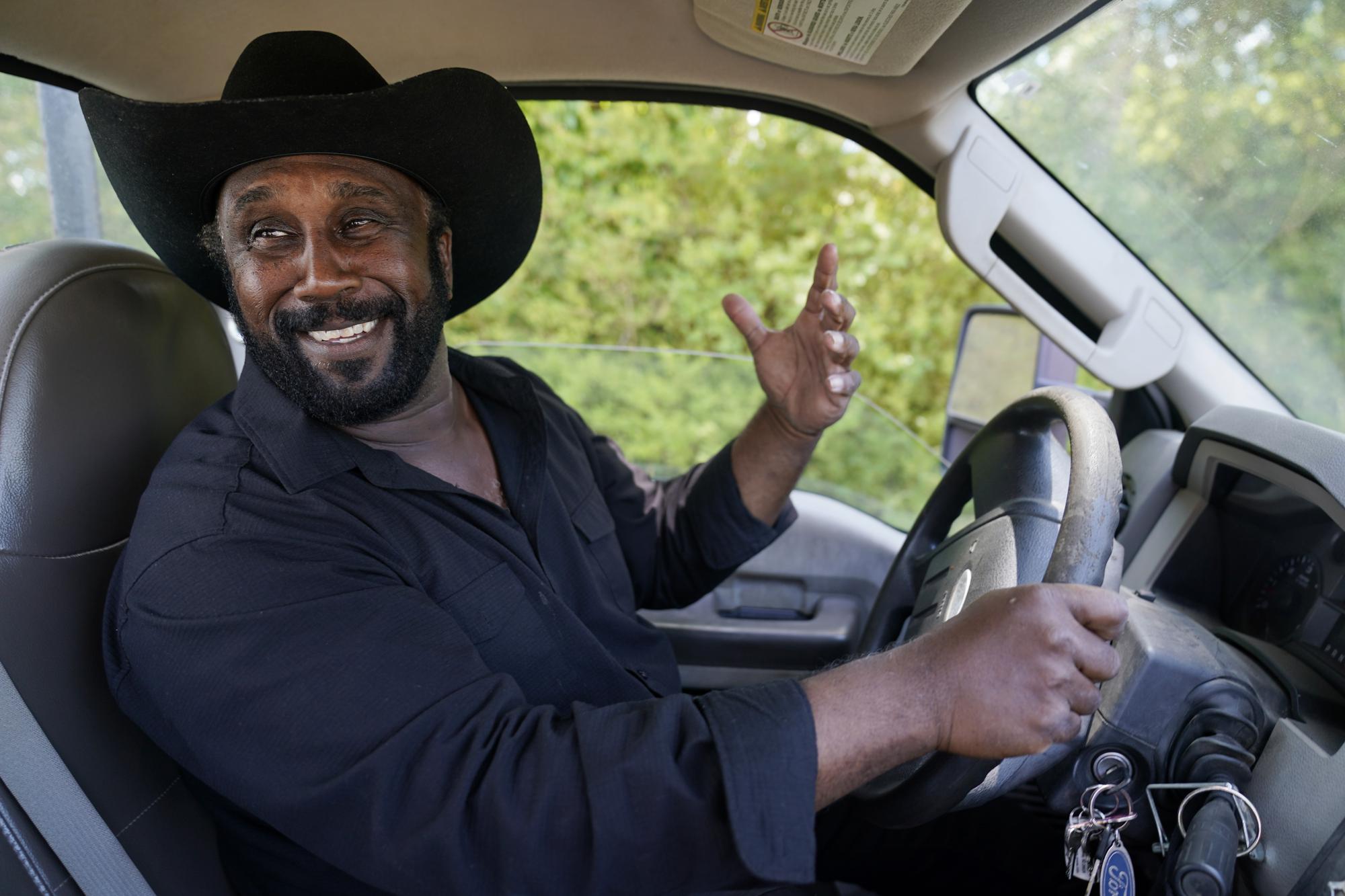 Farmer John Boyd Jr., smiles as he drives his truck on his farm in Boydton, Va., Thursday, May 27, 2021. (AP Photo/Steve Helber)