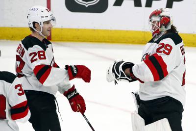 New Jersey Devils defenseman Damon Severson (28) celebrates a 4-3 victory with goaltender Mackenzie Blackwood (29) following an NHL hockey game against the Buffalo Sabres, Wednesday, Dec. 29, 2021, in Buffalo, N.Y. (AP Photo/Jeffrey T. Barnes)