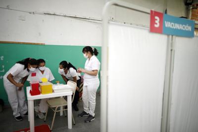 ARCHIVO - En esta foto de archivo del 18 de febrero de 2021, enfermeras leen instrucciones sobre cómo administrar la vacuna Sputnik V contra COVID-19 en una escuela pública de Bernal, en las afueras de Buenos Aires, Argentina. (AP Foto/Natacha Pisarenko, Archivo)