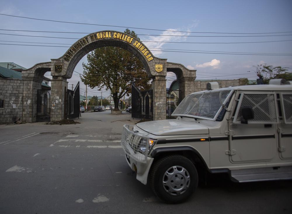 A paramilitary vehicle passes the front gate of Government Medical College in Srinagar, Indian controlled Kashmir, Tuesday, Oct. 26, 2021. Police have registered two separate cases under harsh anti-terror law against students and some staff of two medical colleges for celebrating Pakistan’s victory over archrival India in a T20 World Cup cricket game. (AP Photo/Mukhtar Khan)