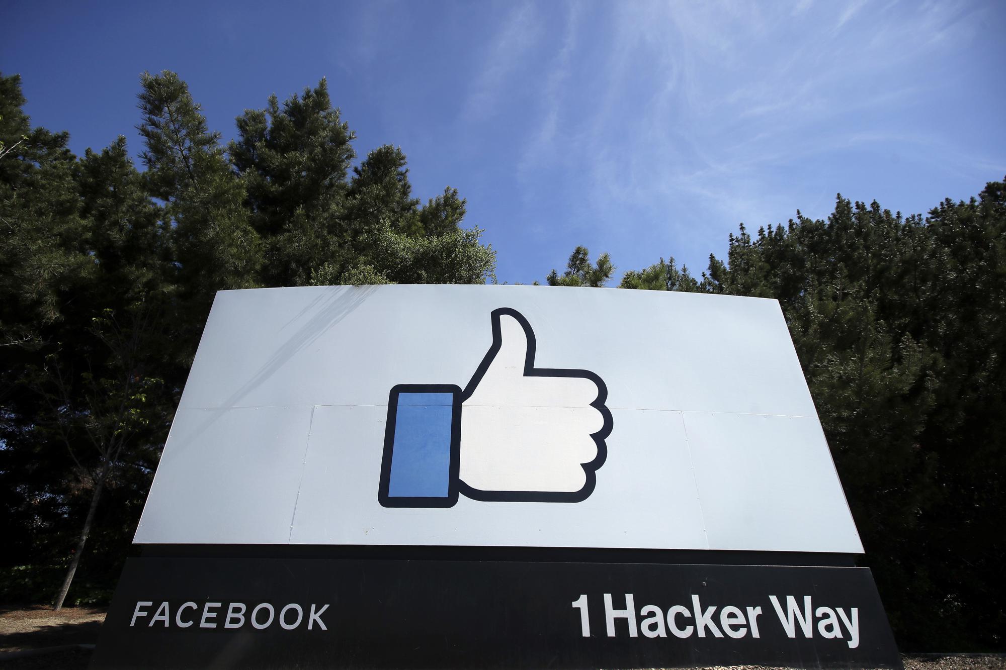 FILE - In this April 14, 2020, file photo, the thumbs up "Like" logo is shown on a sign at Facebook headquarters in Menlo Park, Calif., USA. From complaints whistleblower Frances Haugen has filed with the SEC, along with redacted internal documents obtained by The Associated Press, the picture of the mighty Facebook that emerges is of a troubled, internally conflicted company, where data on the harms it causes is abundant, but solutions are halting at best. (AP Photo/Jeff Chiu, File)