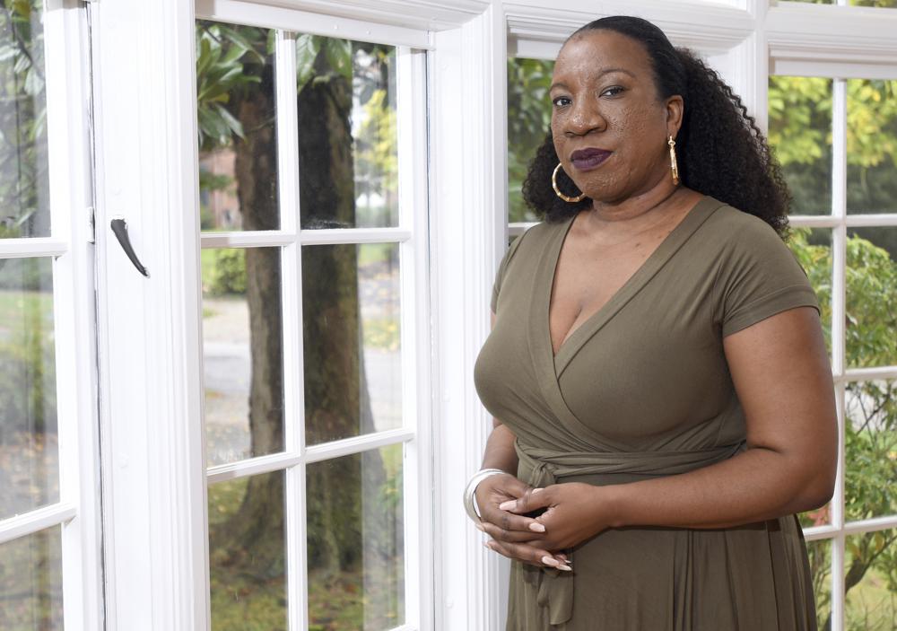 FILE - Tarana Burke, founder and leader of the #MeToo movement, stands in her home in Baltimore on Oct. 13, 2020. Burke released her memoir, "Unbound: My Story of Liberation and the Birth of the Me Too Movement" on  Sept. 14, 2021. (AP Photo/Steve Ruark, File)