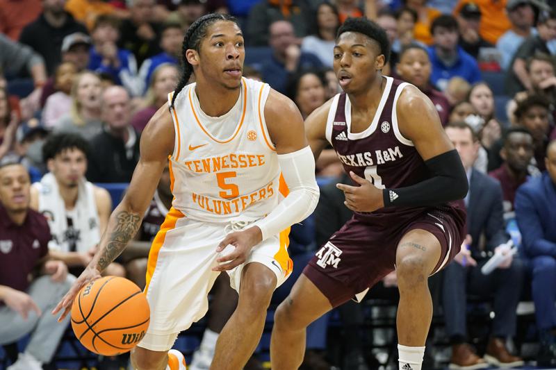 Tennessee guard Zakai Zeigler (5) drives past Texas A&M guard Wade Taylor IV (4) during the first half of an NCAA men's college basketball Southeastern Conference tournament championship game Sunday, March 13, 2022, in Tampa, Fla. (AP Photo/Chris O'Meara)