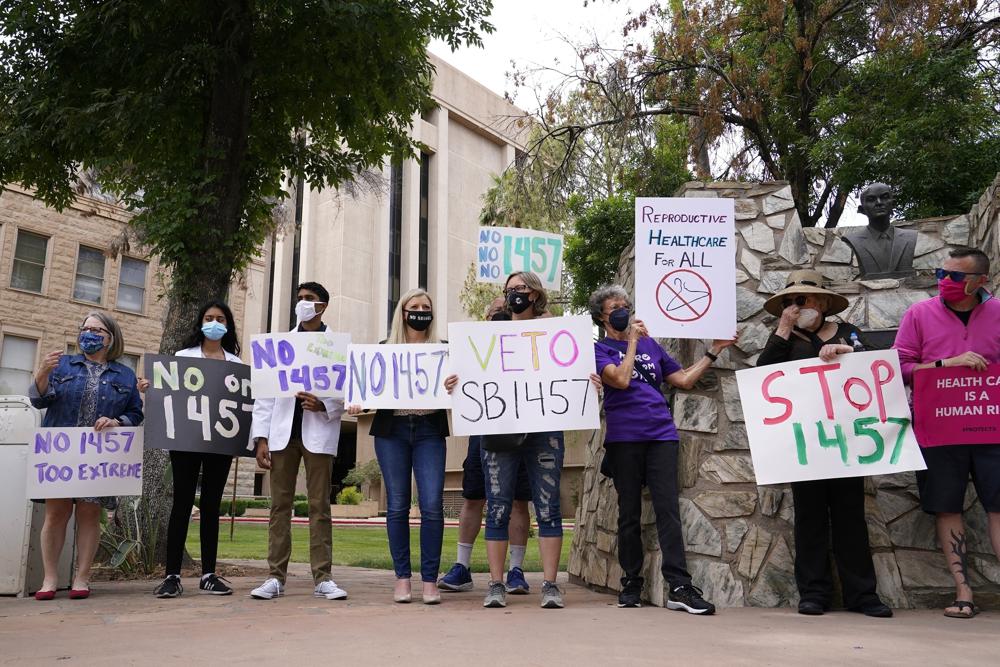 FILE — A number of Arizona reproductive health, rights, and justice advocates protest an abortion bill at the Arizona Capitol Monday, April 26, 2021, in Phoenix. Arizona governor Doug Ducey signed a series of bills Wednesday, March 30, targeting abortion and transgender rights, joining a growing list of GOP-led states pursuing a conservative social agenda.  (AP Photo/Ross D. Franklin, File)