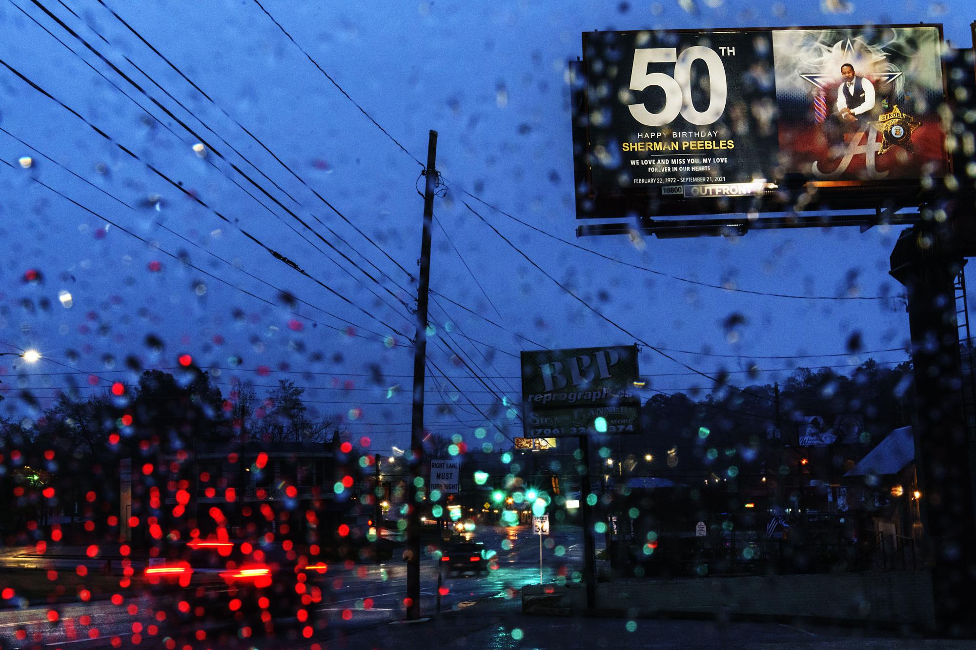 A billboard put up by ShiVanda Peebles celebrates what would have been her husband Sherman's 50th birthday, in Columbus, Ga., Wednesday, March 9, 2022. Sherman Peebles doted on his wife, his sweetheart since high school. The couple ran a business together but their partnership was much more. After ShiVanda had a kidney transplant, he turned their trips to Atlanta for continued care into mini-vacations, taking her to Braves games and out for dinner. "He called me his queen," she says. Sherman Peebles died at age 49 from COVID in September. (AP Photo/David Goldman)